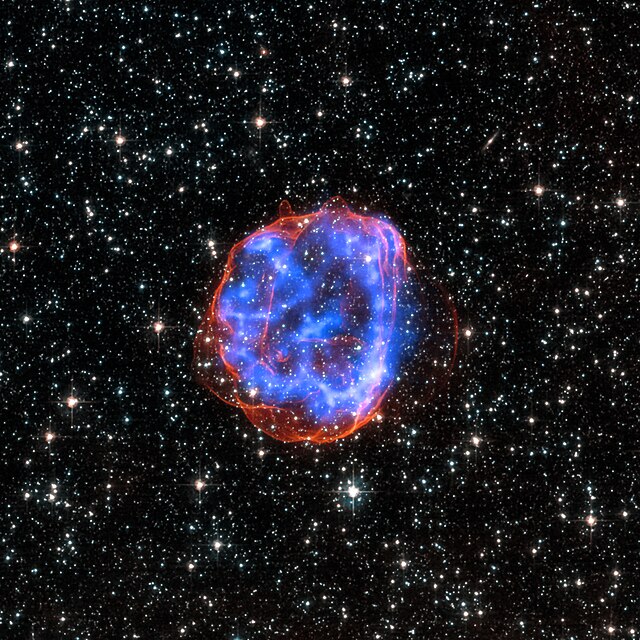 A blooming cloud of blue gas in space, the remnant of an exploding star.