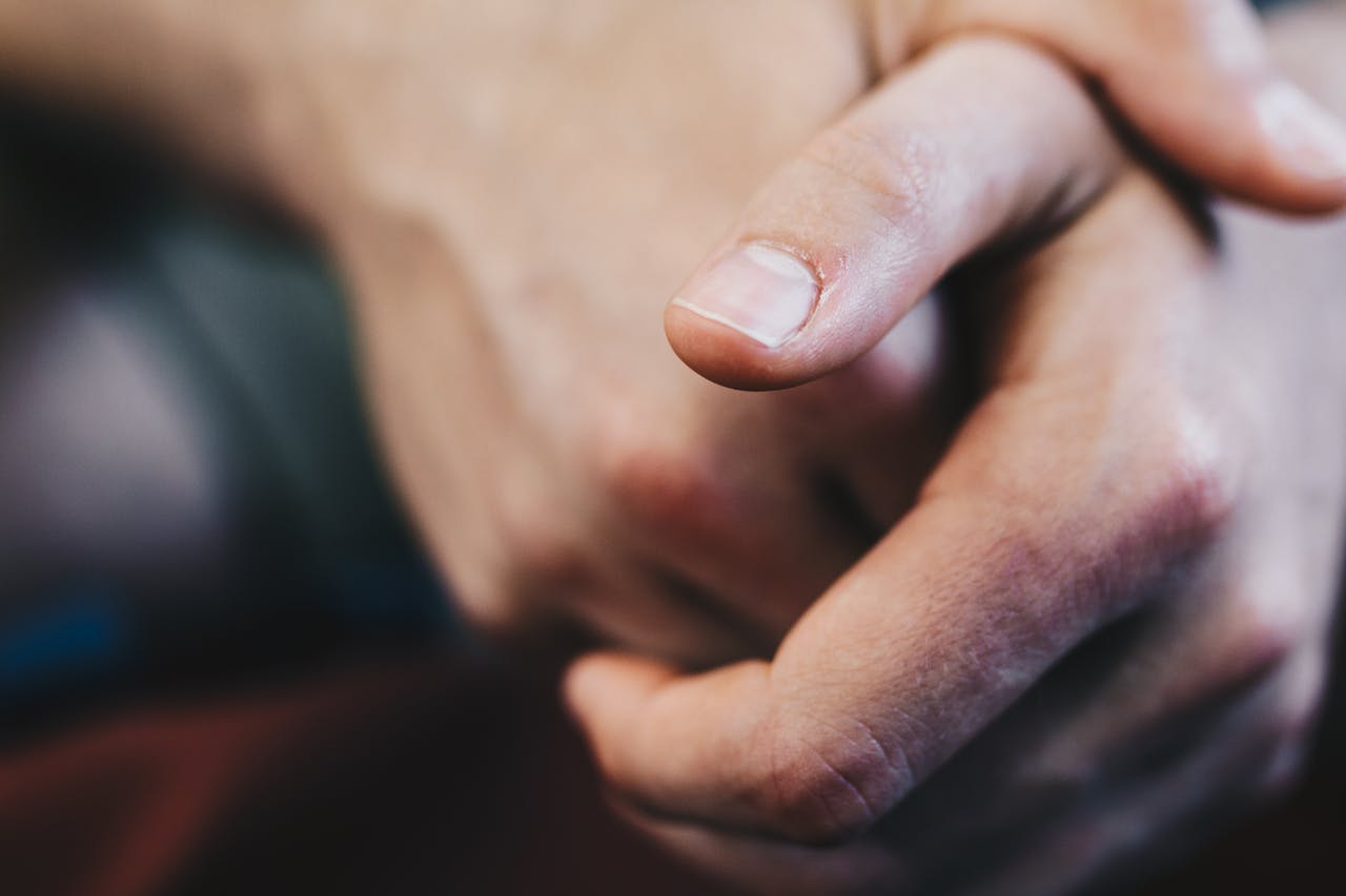 One person's hands loosely clasped