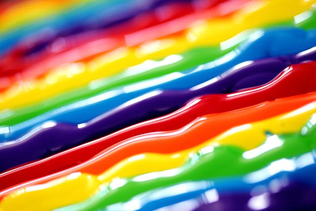 Stripes of wet paint, still wet and glistening. Bold rainbow colors.